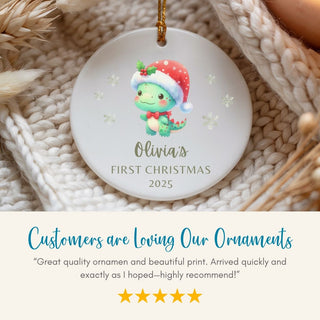 Personalized Christmas ornament with a baby dragon design and text on a textured surface.