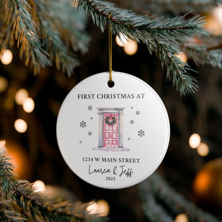 Custom new home ornament hanging on Christmas tree; snowy door design with wreath and personalized family address.