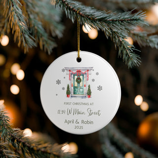 Personalized Christmas ornament hanging on a tree with festive lights in the background