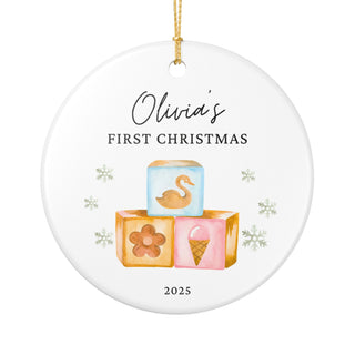 Personalized baby’s first Christmas ornament featuring pastel baby toys design. Custom ceramic keepsake with name and birth details.