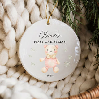 Personalized Christmas ornament with a bear illustration and text on a textured surface.