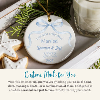 Personalized Christmas ornament with blue ribbon and text, placed on a festive surface with cookies and milk.