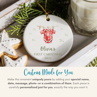 Personalized Christmas ornament with baby onesie design on a table with cookies and milk.