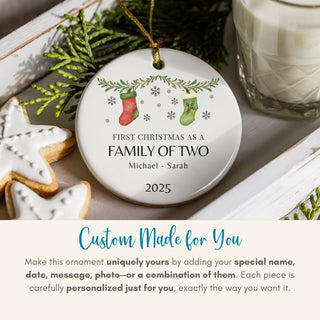 Personalized Christmas ornament with stockings design, placed on a table with cookies and a glass of milk.