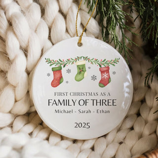 Christmas ornament with stockings and text on a textured surface