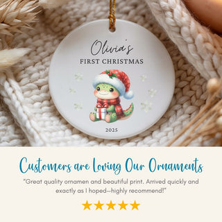 Personalized Christmas ornament with a child's name and year, displayed on a textured surface.