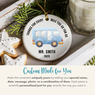 Personalized Christmas ornament with a blue bus design, text, and customization information.
