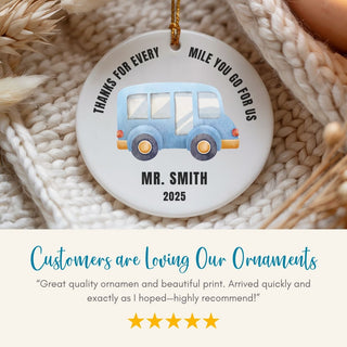 Decorative ornament with a blue bus design, text, and a five-star rating on a textured surface.
