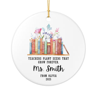 round ornament featuring watercolor bookshelf with colorful books and florals; teacher appreciation keepsake; ready to hang; suitable for classroom or home